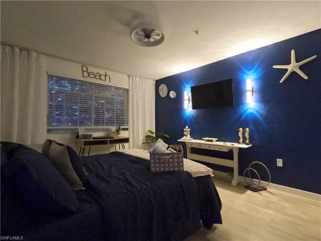 Bedroom with wood finished floors and baseboards