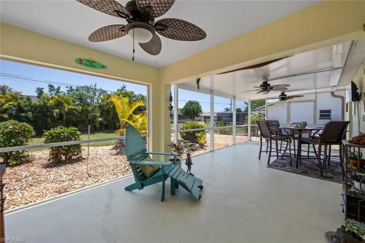 Sunroom / solarium with a ceiling fan and outdoor dining area