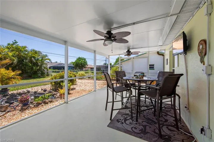 Sunroom featuring ceiling fan and outdoor dining space