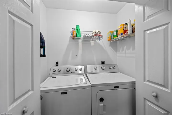 Washroom featuring washing machine and dryer