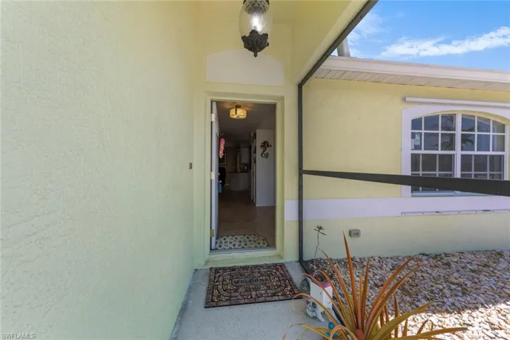 Entrance to property featuring stucco siding