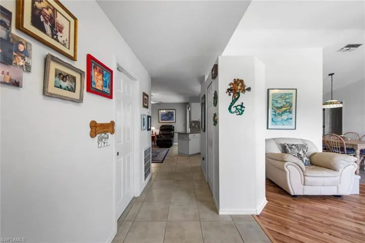 Corridor with baseboards and light tile patterned floors