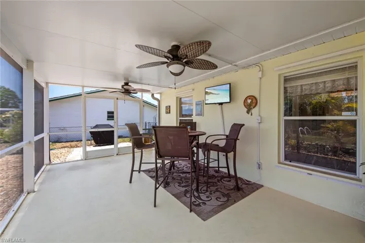 Sunroom featuring ceiling fan and outdoor dining space