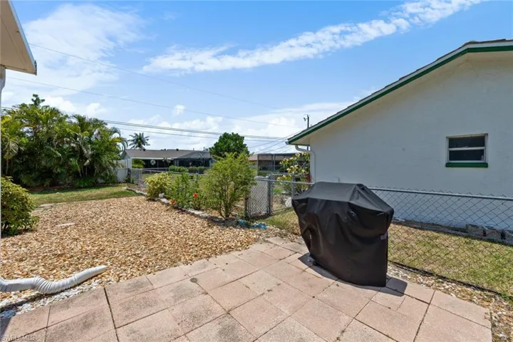View of patio with a fenced backyard and grilling area