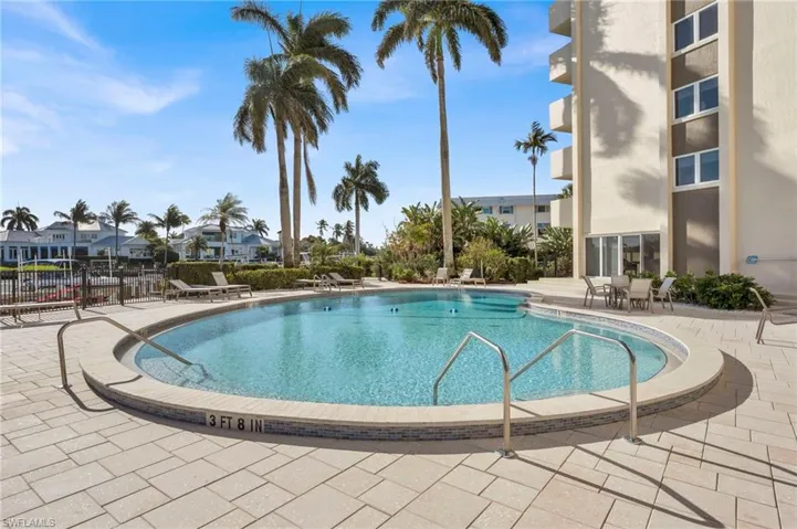 Community pool with a patio