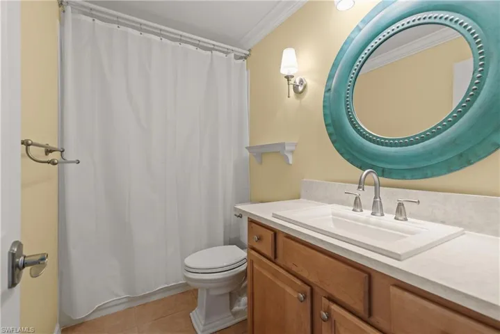Bathroom #3 on 2nd floor featuring vanity, light tile patterned floors, crown molding, and a shower with curtain