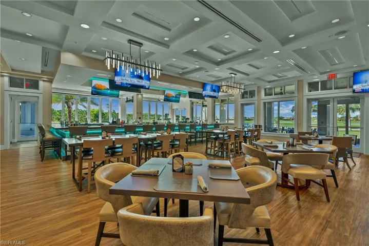 Dining area with coffered ceiling, healthy amount of natural light, beamed ceiling, recessed lighting, and wood finished floors