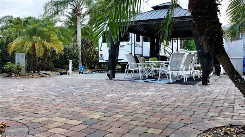 View of patio featuring outdoor dining area and a gazebo