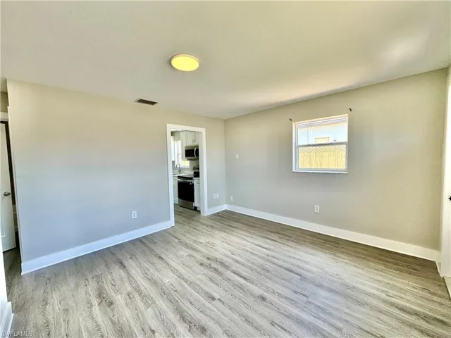 Spare room with light wood-type flooring and baseboards