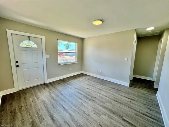 Foyer with baseboards and light wood-style floors