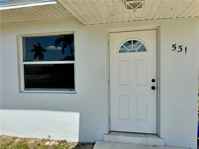 Entrance to property with stucco siding