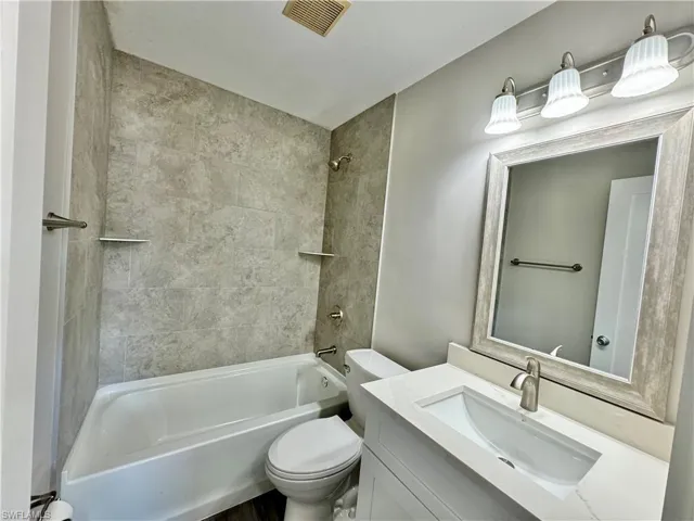 Bathroom featuring bathtub / shower combination and vanity