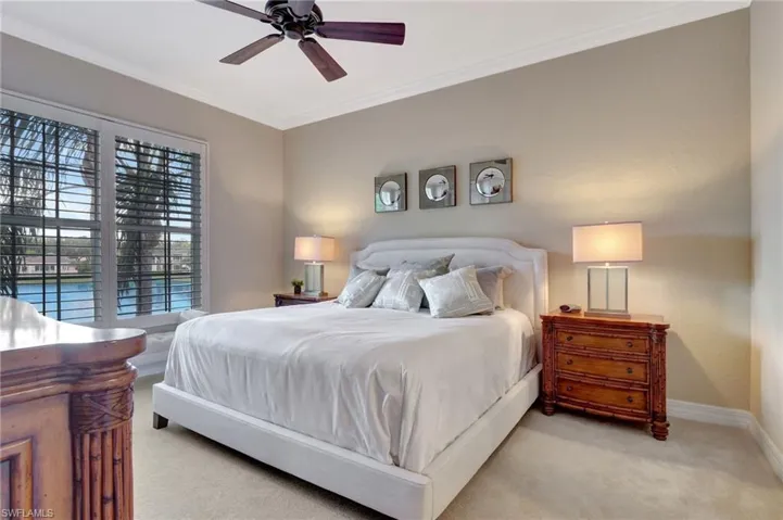 Carpeted Master Bedroom with ceiling fan and crown molding