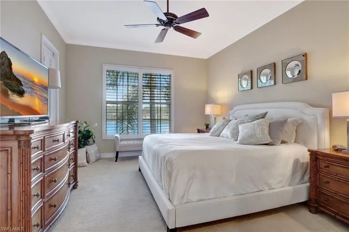 Master Bedroom featuring ceiling fan, light colored carpet, and crown molding