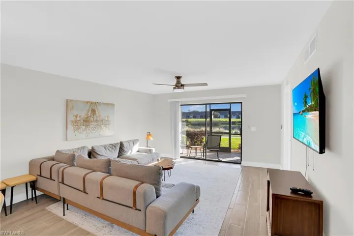 Living room with wood tiled floors and ceiling fan