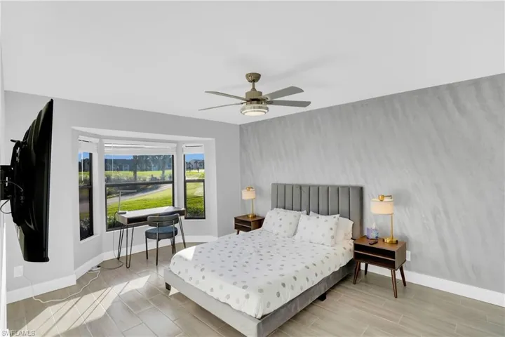 Bedroom featuring wood tiled floors and ceiling fan