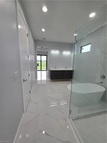 Bathroom featuring tile flooring and shower with separate bathtub