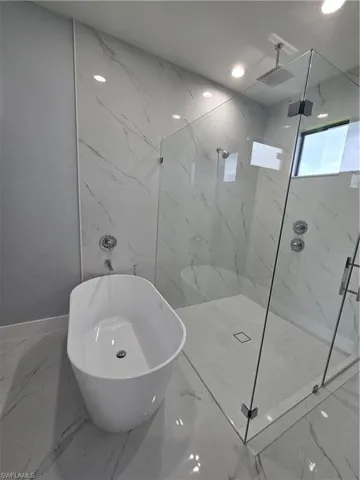 Bathroom with a tile shower and tile flooring