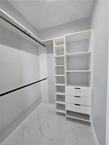 Walk in closet with tile floors