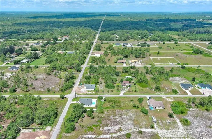 Aerial view of property's location featuring a forest