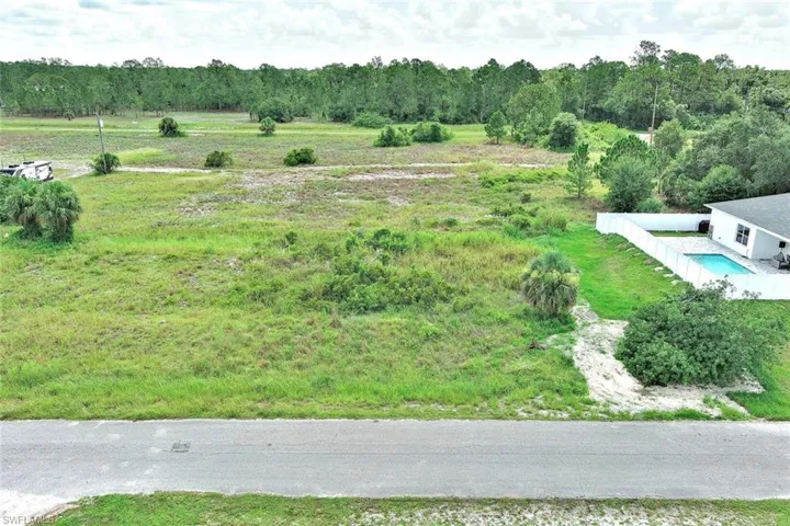 Aerial view of sparsely populated area with a forest