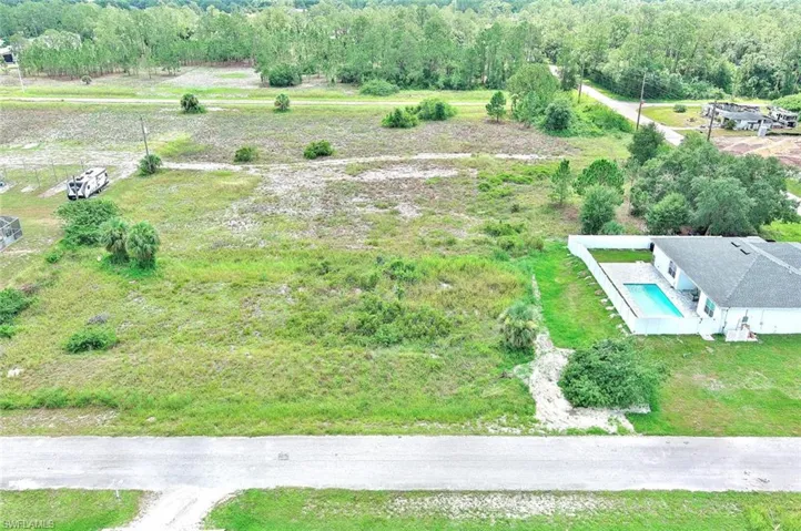 Aerial view of property and surrounding area featuring a pool area