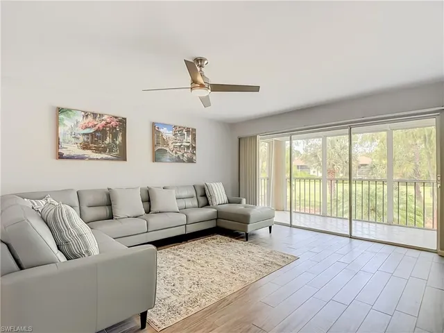 Living area with plank-style flooring and a ceiling fan