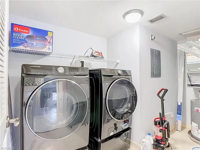 Dedicated laundry area featuring modern front-load washer and dryer units
