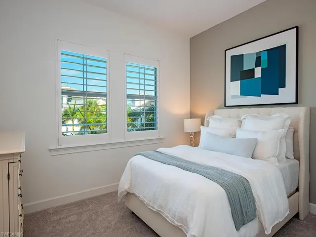 Carpeted bedroom with baseboards
