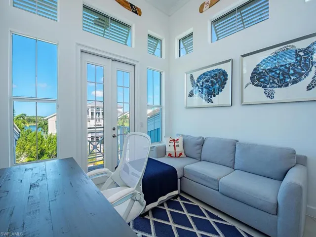 Sunroom with plenty of natural light, french doors, and a towering ceiling
