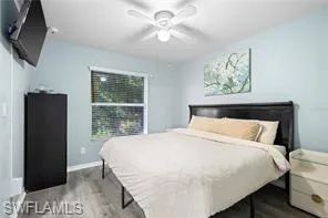 Bedroom with baseboards, ceiling fan, and wood finished floors