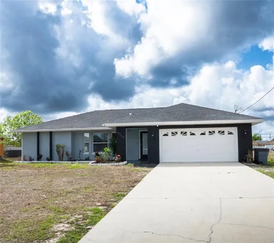 Ranch-style home featuring a garage, concrete driveway, stucco siding, and a shingled roof