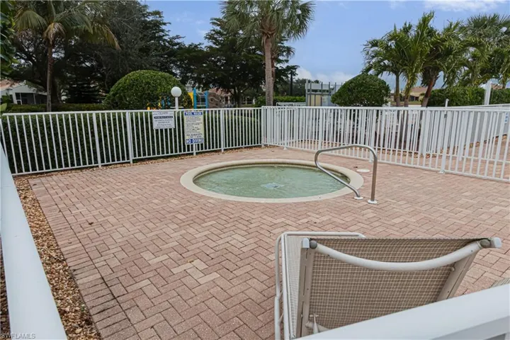 View of pool with a hot tub