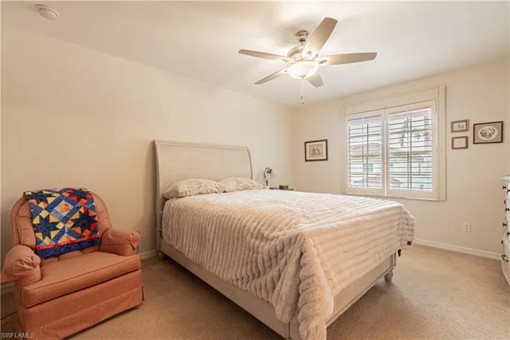 Bedroom featuring light colored carpet and ceiling fan