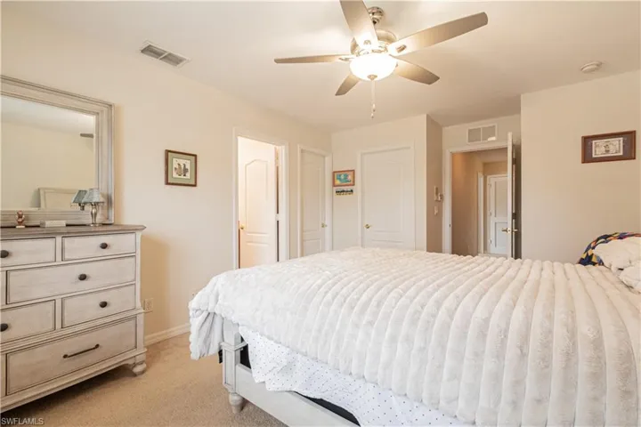Bedroom featuring ceiling fan and light carpet
