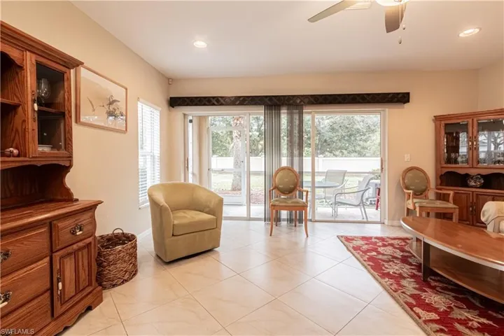 Sitting room featuring light tile patterned floors, ceiling fan, and plenty of natural light