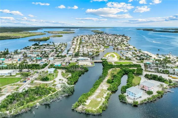 Aerial perspective of suburban area featuring a large body of water
