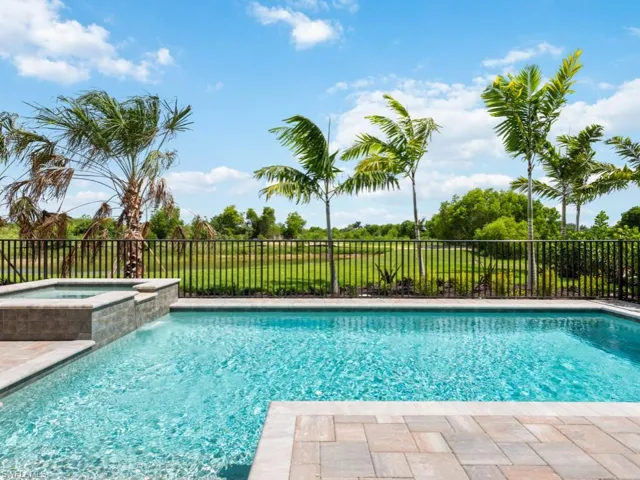 View of swimming pool featuring an in ground hot tub