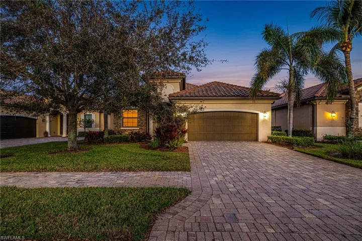 Mediterranean / spanish home with a yard and a garage