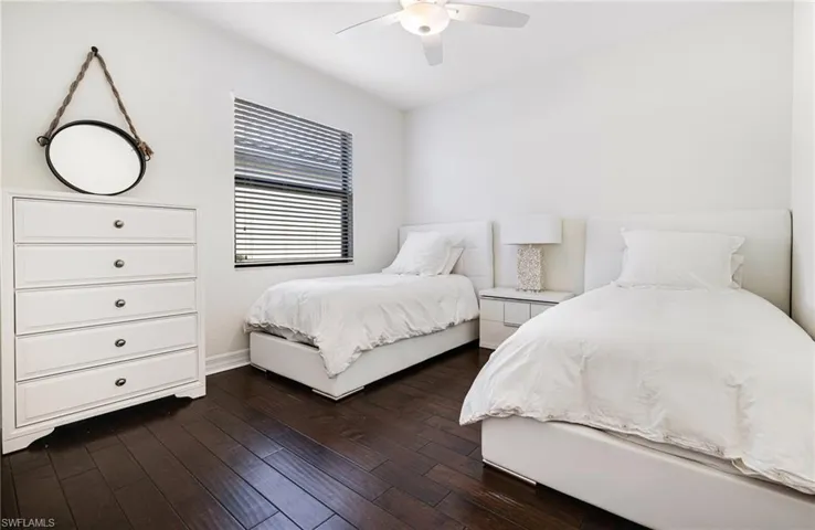 Bedroom with dark wood-type flooring and ceiling fan