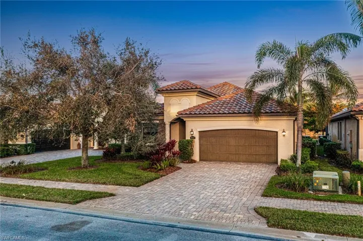 Mediterranean / spanish home featuring a garage