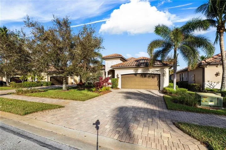 Mediterranean / spanish-style home with a garage