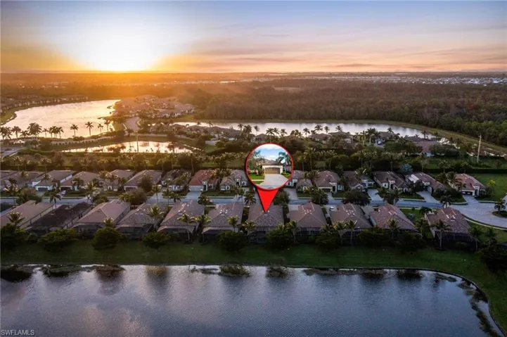Aerial view at dusk featuring a water view