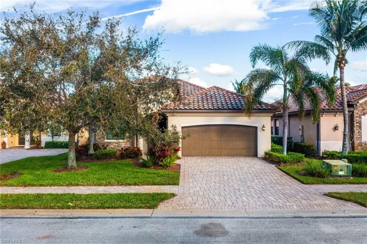 View of front of house with a front yard and a garage