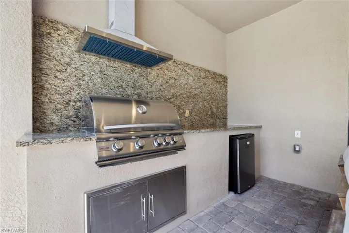 View of patio with an outdoor kitchen and area for grilling