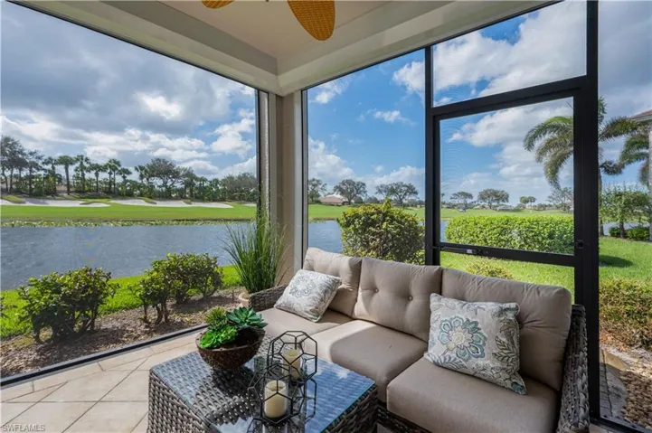 Sunroom with a water view and ceiling fan