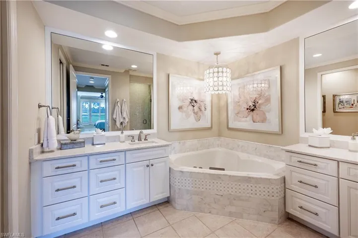 Bathroom with vanity, crown molding, shower with separate bathtub, and tile patterned flooring