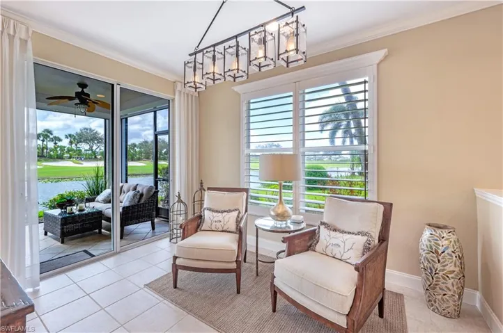 Living area featuring ornamental molding, ceiling fan, and light tile patterned floors