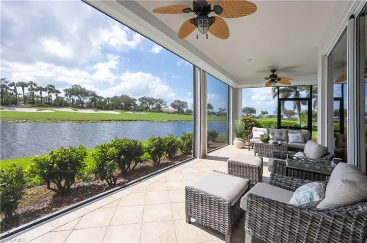 Sunroom / solarium featuring a water view and ceiling fan