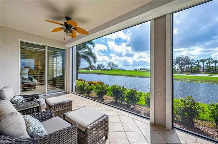 Sunroom with a water view and ceiling fan